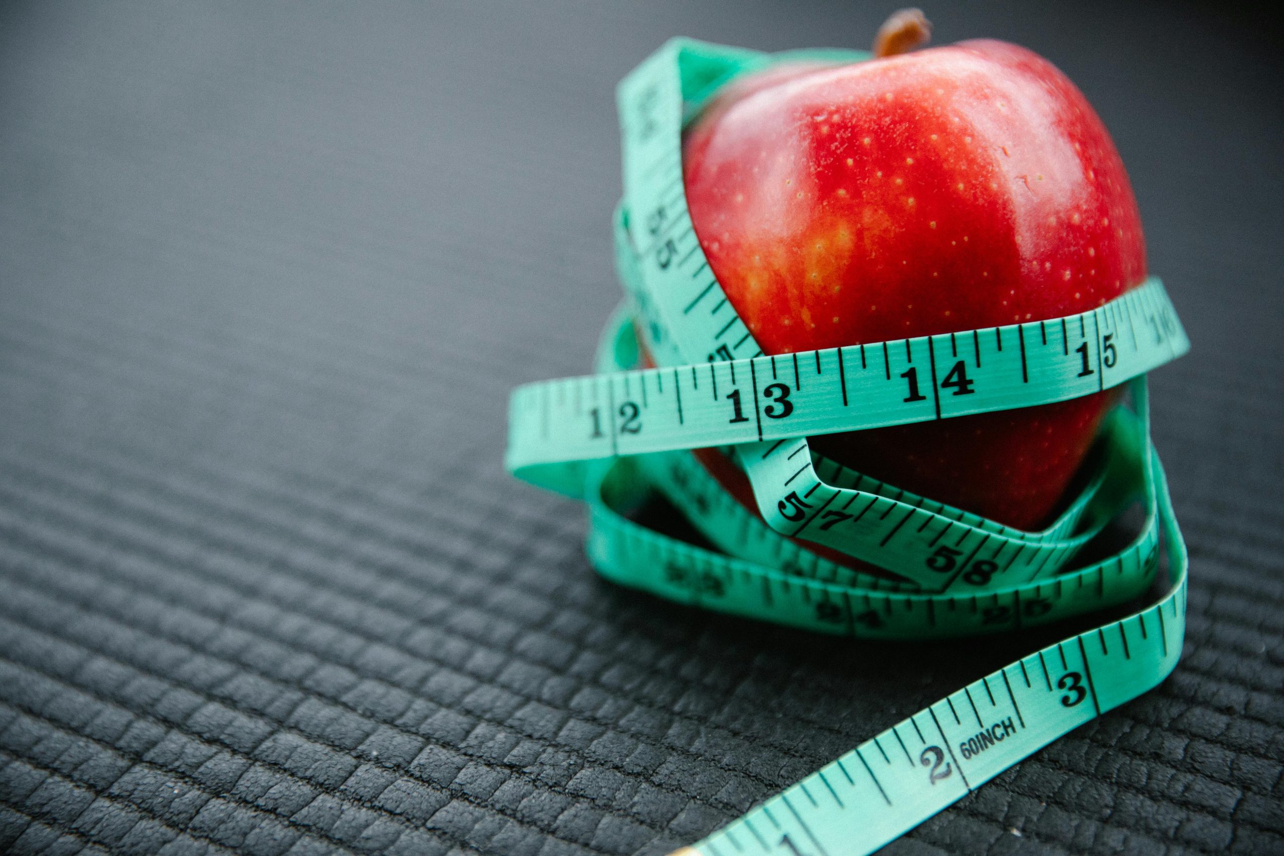 Apple wrapped in a tape measure